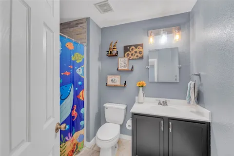 a white toilet sitting next to a bathroom sink