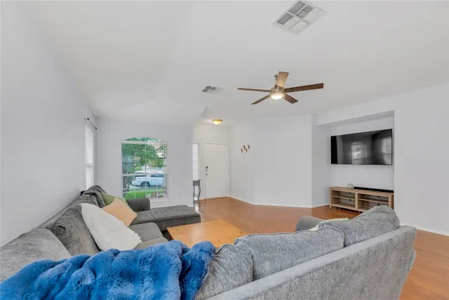 a living room with furniture and a flat screen tv