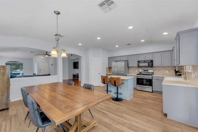 a large kitchen with a table and chairs