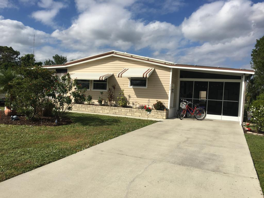 108 Audubon Road Naples, FL 34114 - Photo 1 of 11 a view of house and outdoor space