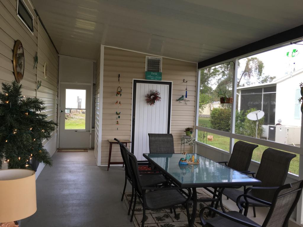 108 Audubon Road Naples, FL 34114 - Photo 11 of 11 a view of a dining room with furniture window and wooden floor