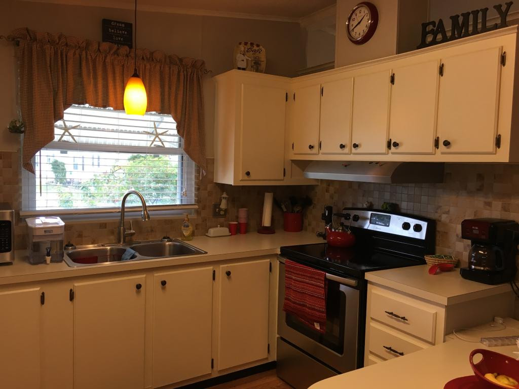 108 Audubon Road Naples, FL 34114 - Photo 4 of 11 a kitchen with a stove a sink and a window