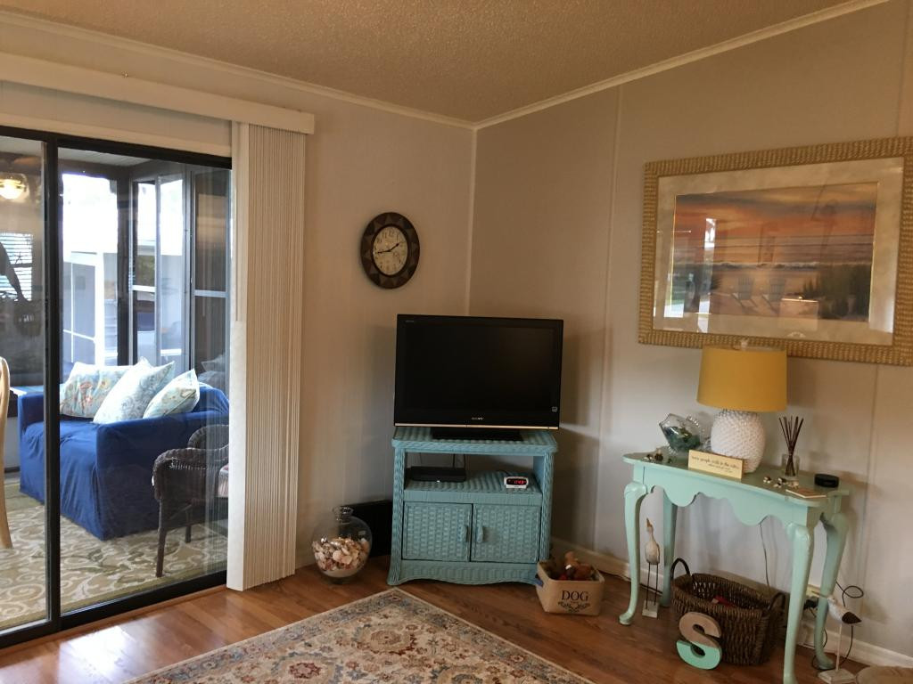108 Audubon Road Naples, FL 34114 - Photo 6 of 11 a living room with furniture and a flat screen tv