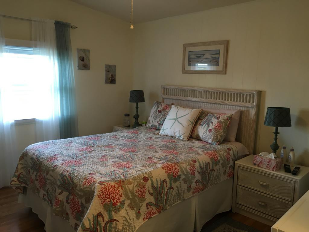 108 Audubon Road Naples, FL 34114 - Photo 7 of 11 a bedroom with a bed and a window