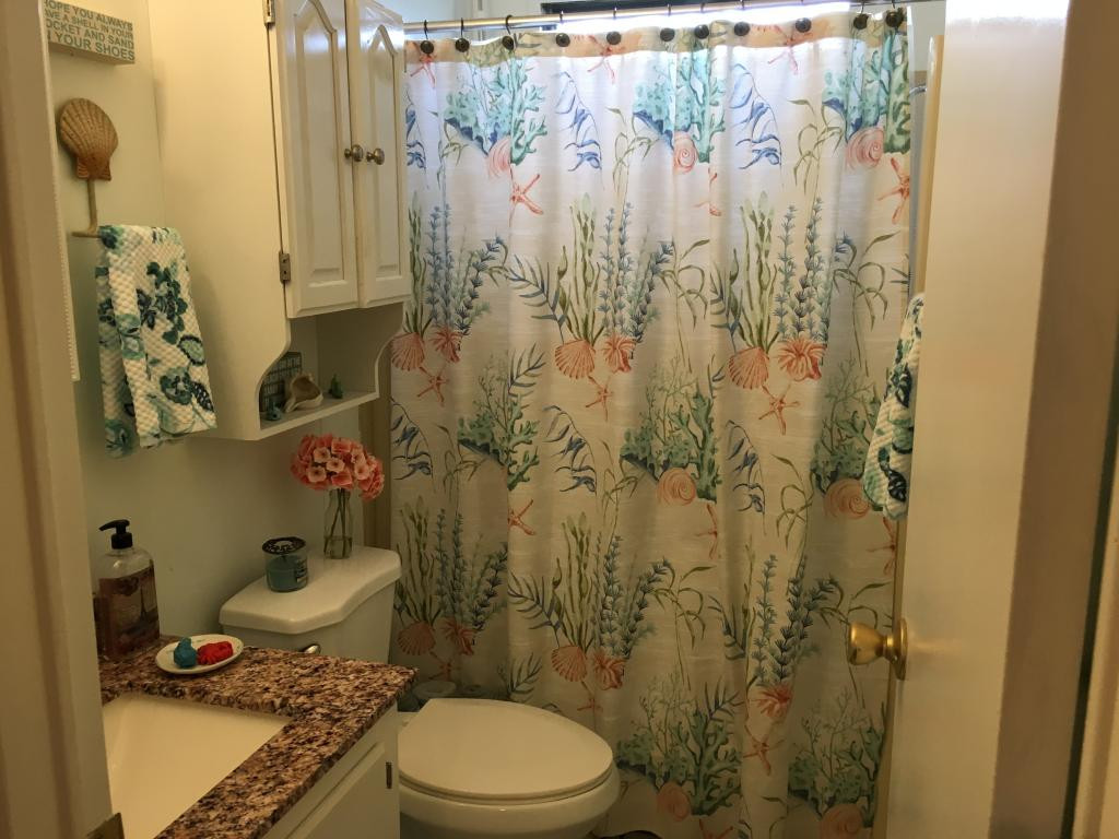 108 Audubon Road Naples, FL 34114 - Photo 10 of 11 a bathroom with a toilet and a shower curtain
