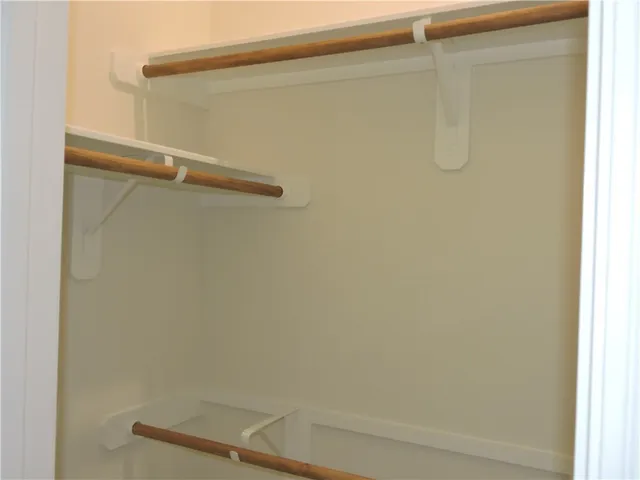 a view of a swimming pool with lawn chairs under an umbrella