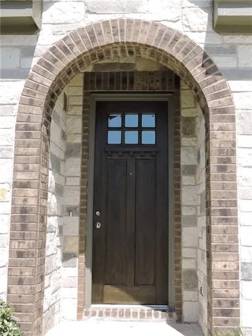 an empty room with windows and mirror