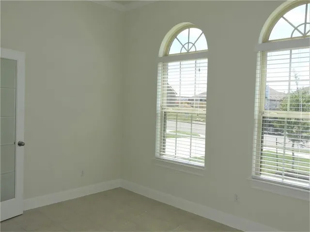 a kitchen with granite countertop a refrigerator and a stove top oven