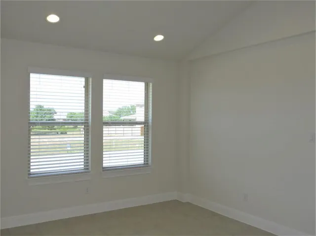 a large kitchen with stainless steel appliances a large counter top a stove and a refrigerator