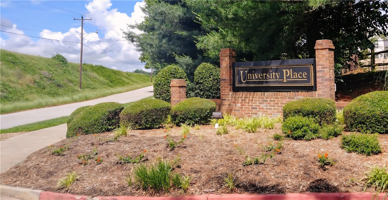 220 Elm Street, Unit 423 Clemson, SC 29631 - Photo 3 of 14 Welcome to this inviting community, marked by a classic brick entrance sign amidst lush greenery.
