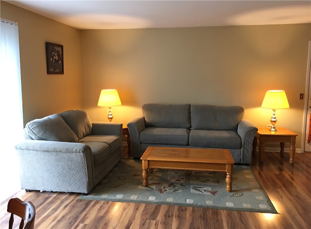 220 Elm Street, Unit 423 Clemson, SC 29631 - Photo 4 of 14 This inviting living space features warm flooring, perfect for cozy gatherings and everyday comfort.