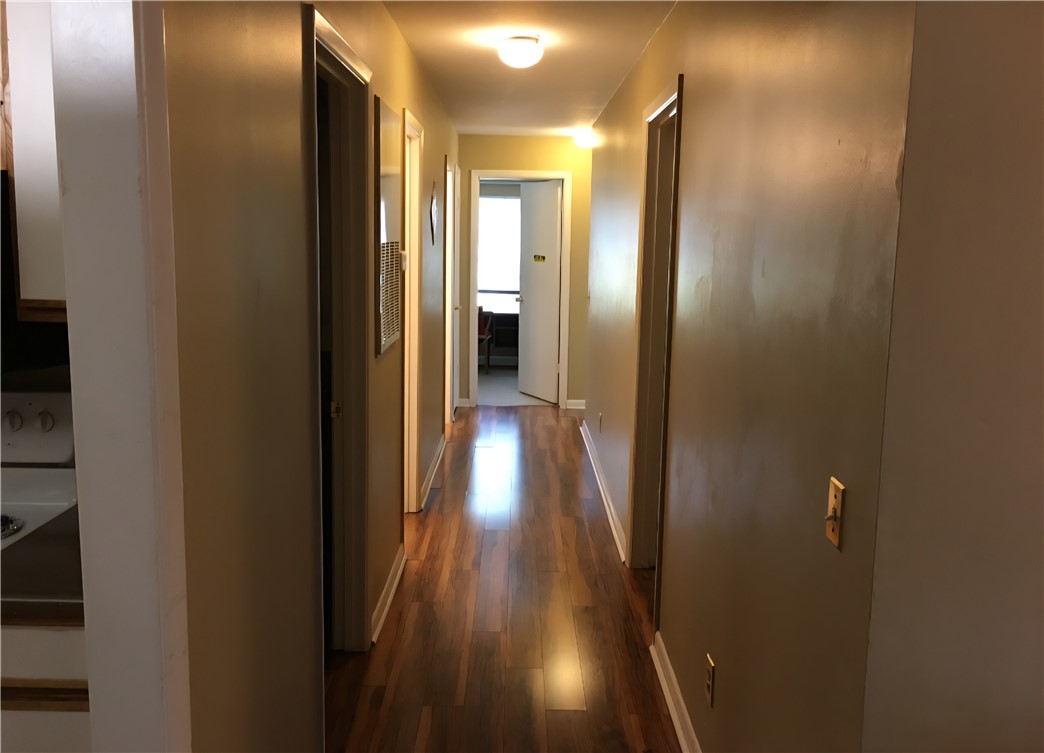220 Elm Street, Unit 423 Clemson, SC 29631 - Photo 7 of 14 This interior hallway features beautiful wood flooring, guiding the way through the home's inviting spaces.