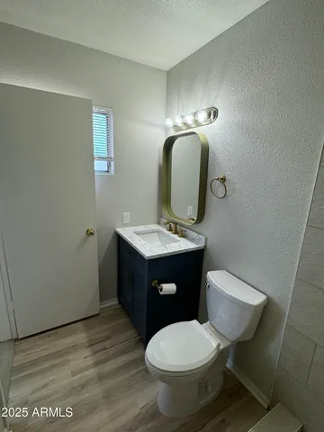 a bathroom with a toilet sink and mirror