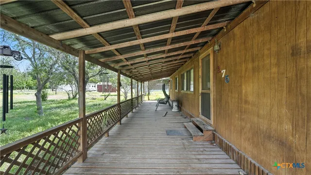 a view of a porch with wooden floor and stairs