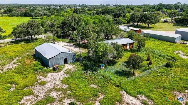 an aerial view of a house with yard swimming pool and outdoor seating