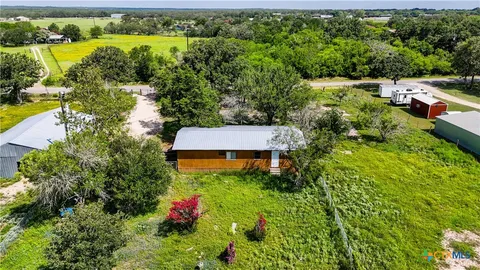 an aerial view of residential house with outdoor space and swimming pool