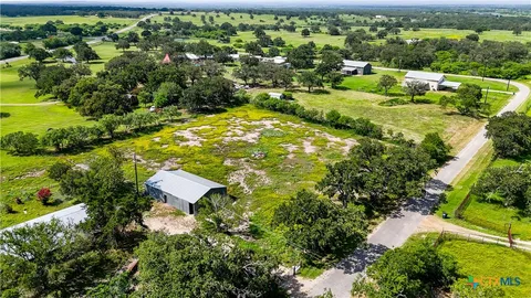 an aerial view of residential houses with outdoor space and street view