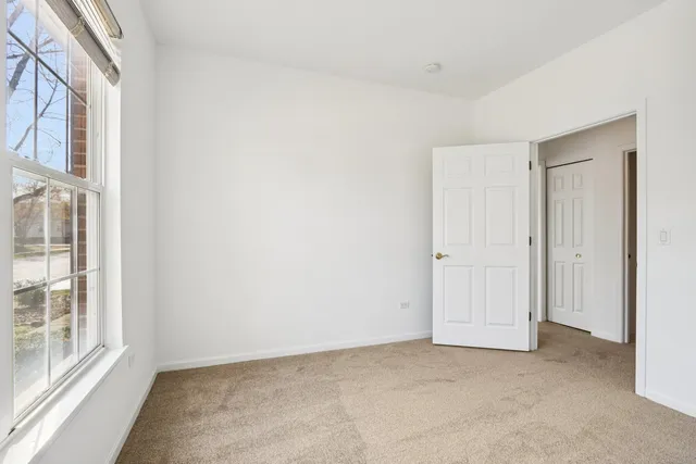 a bathroom with a granite countertop toilet a sink and a mirror