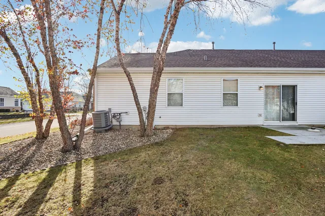 a backyard of a house with yard and outdoor seating