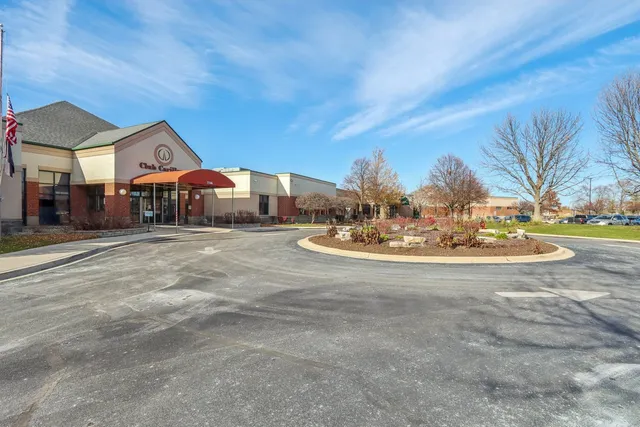 a front view of a house with a yard and porch