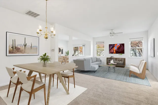 a view of a dining room with furniture a livingroom and wooden floor