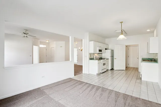 a kitchen with granite countertop a stove sink and refrigerator