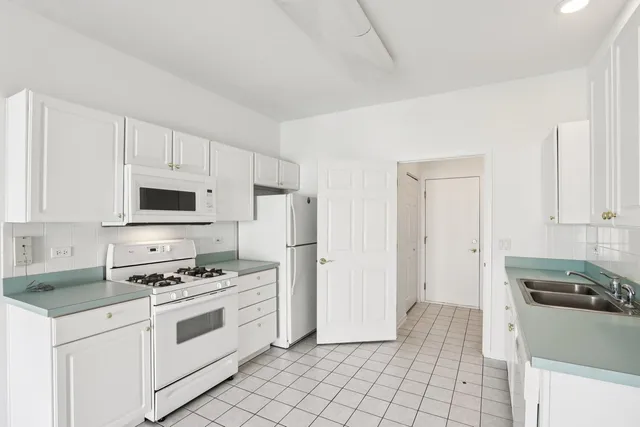 a kitchen with a sink stove and refrigerator