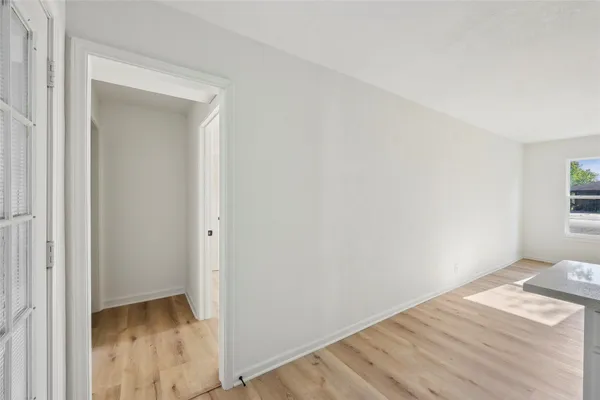 a view of room with wooden floor