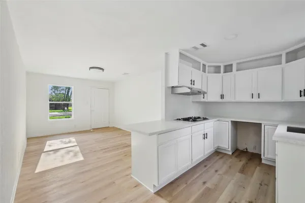 a kitchen with stainless steel appliances granite countertop a stove and a sink with cabinets