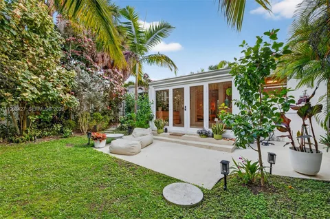 a view of a house with backyard sitting area and entertaining space
