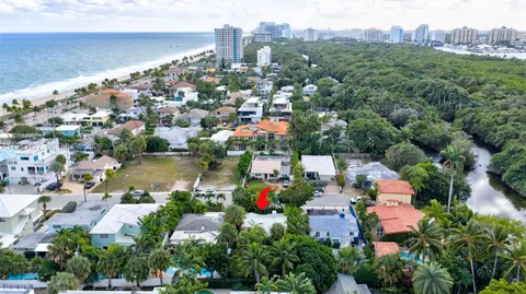an aerial view of house with yard and lake view