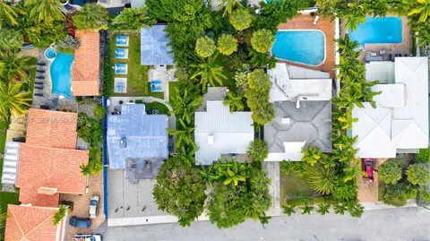 an aerial view of multiple houses with yard