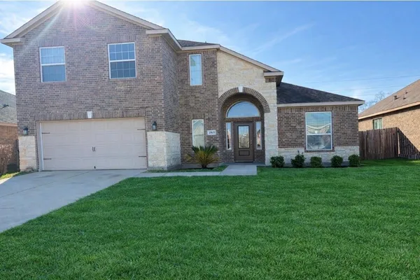 a front view of house with yard and green space