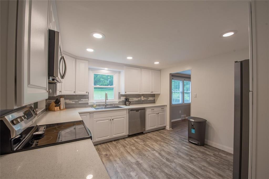 211 Rush Valley Road Monroeville, PA 15146 - Photo 12 of 25 Recessed Lights and wood look laminate floors!