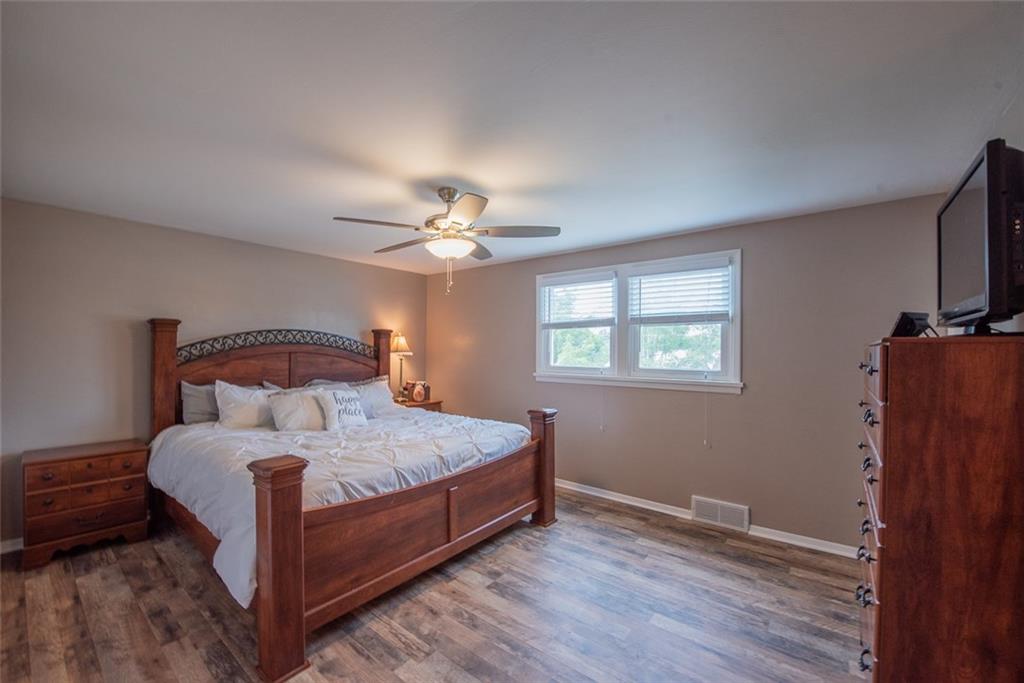 211 Rush Valley Road Monroeville, PA 15146 - Photo 15 of 25 Master Bedroom with New Laminate Wood Look Floors, Double Closets, sitting area or future Walk in Closet, and New Ceiling Fan.