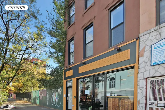 a room with gym equipment and a kitchen view
