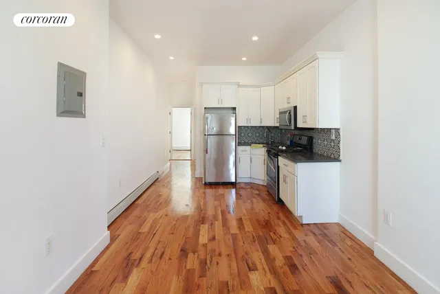 a kitchen with a refrigerator and a stove top oven