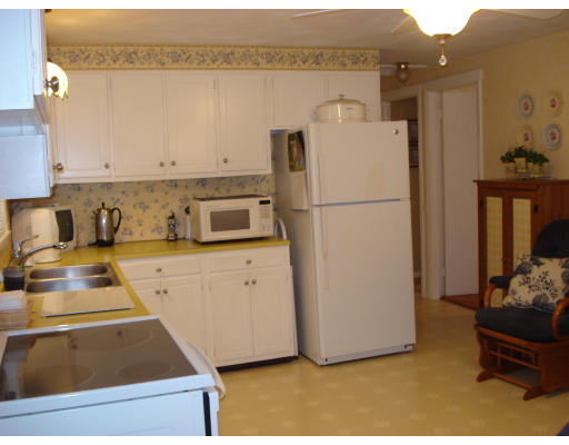72 Corey Road Springfield, MA 01128 - Photo 12 of 26 a kitchen with a refrigerator sink and cabinets