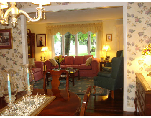 72 Corey Road Springfield, MA 01128 - Photo 7 of 26 a living room with fireplace furniture and a floor to ceiling window