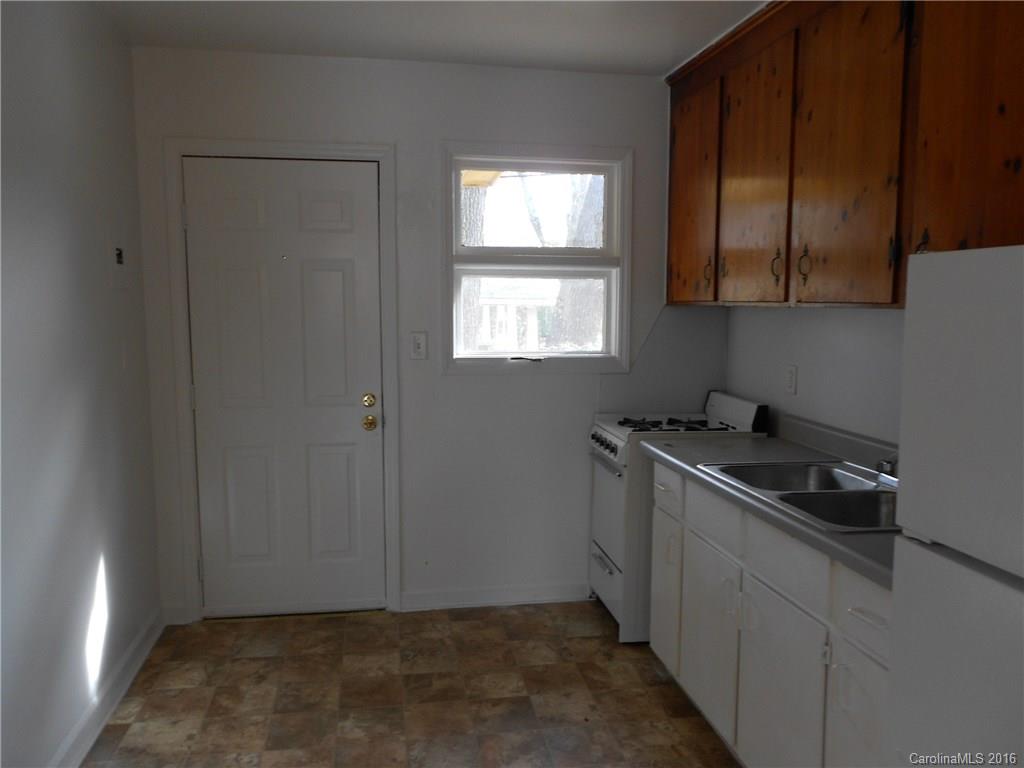 3830 Tuckaseegee Road, Unit 1 Charlotte, NC 28208 - Photo 3 of 6 a kitchen with a stove and a window