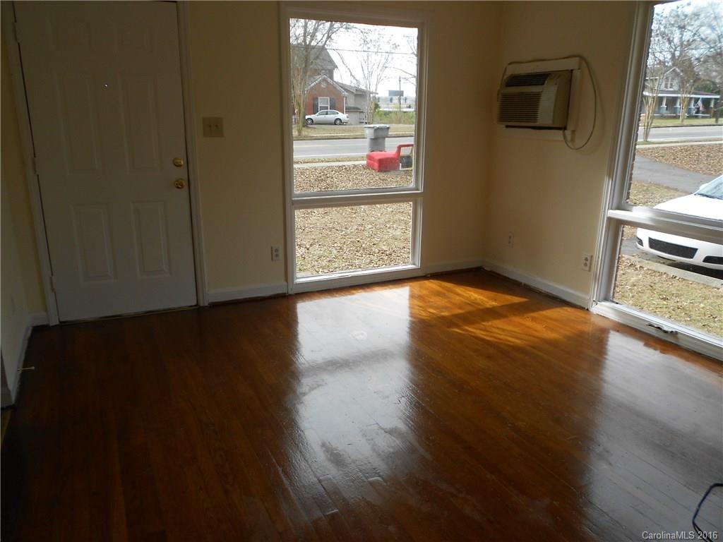 3830 Tuckaseegee Road, Unit 1 Charlotte, NC 28208 - Photo 4 of 6 a view of an empty room with wooden floor and a window