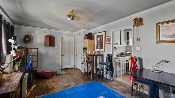 a view of a livingroom with wooden floor and furniture