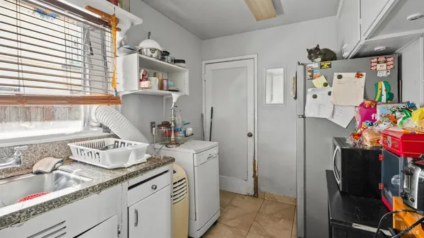 a bathroom with a sink vanity granite and a shower