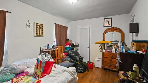 a bedroom with bed and a wooden floor