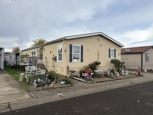 a backyard of a house with bicycles parked in front of it