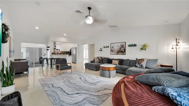 a living room with furniture and view of kitchen