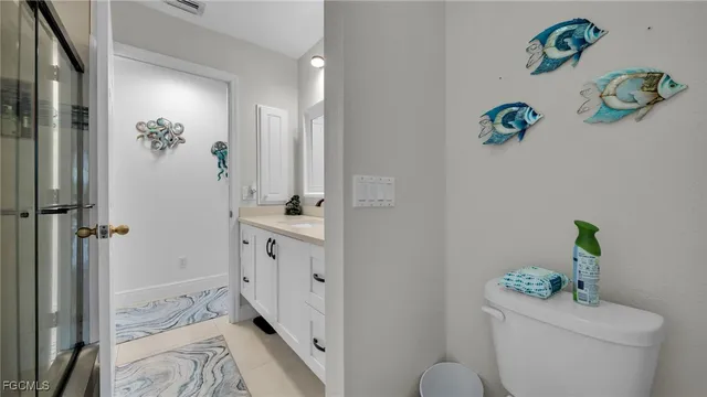 a bathroom with a sink mirror and toilet
