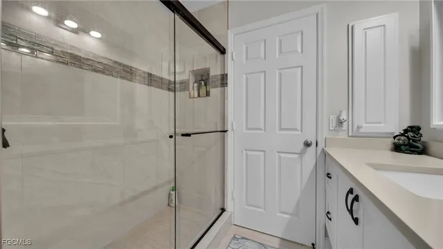 a bathroom with a sink vanity and a mirror