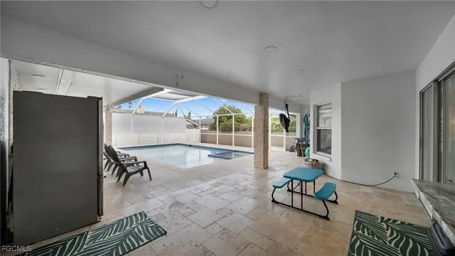 a dining room with furniture and a floor to ceiling window
