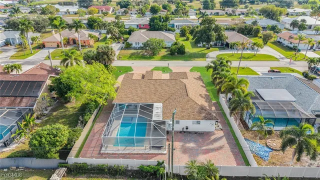 an aerial view of residential houses with outdoor space and swimming pool
